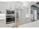 White kitchen with built-in appliances and a walk-in pantry for ample storage at 3545 Donlin Dr, Wake Forest, NC 27587