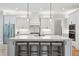 Bright, modern kitchen with a large island, stylish pendant lighting, and sleek, white cabinetry at 3545 Donlin Dr, Wake Forest, NC 27587