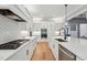 Galley kitchen with white cabinets, stainless steel appliances, and a center island with sink at 3545 Donlin Dr, Wake Forest, NC 27587
