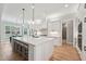 Bright kitchen featuring a large island with seating, stainless appliances, and a dining area at 3545 Donlin Dr, Wake Forest, NC 27587