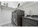 Convenient laundry room with modern washer and dryer, sink, and storage shelving at 3545 Donlin Dr, Wake Forest, NC 27587