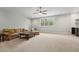Spacious living room with neutral carpeting, a ceiling fan, and natural lighting at 3545 Donlin Dr, Wake Forest, NC 27587