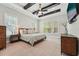 Serene main bedroom with tray ceilings, a ceiling fan, and natural light pouring in through large windows at 3545 Donlin Dr, Wake Forest, NC 27587