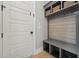 Functional mudroom with built-in bench, storage cubbies, hooks, and door at 3545 Donlin Dr, Wake Forest, NC 27587
