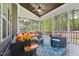 Relaxing screened porch with ample seating, a ceiling fan, and serene wooded views at 3545 Donlin Dr, Wake Forest, NC 27587
