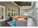Comfortable screened-in porch features stylish furniture, a ceiling fan, and wooded views at 3545 Donlin Dr, Wake Forest, NC 27587