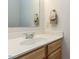 Bathroom vanity featuring wood cabinets, a white sink, quartz countertop and gold fixtures at 3608 Burwell Rollins Cir, Raleigh, NC 27612