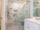 Beautiful bathroom with marble counters and glass shower with built-in shower seat at 3608 Burwell Rollins Cir, Raleigh, NC 27612
