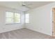 Bedroom featuring carpet, two windows, and fresh white paint to create a bright atmosphere at 3608 Burwell Rollins Cir, Raleigh, NC 27612