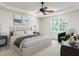 Bright main bedroom with a tray ceiling, stylish ceiling fan, and a window view at 3608 Burwell Rollins Cir, Raleigh, NC 27612