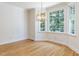 Open dining area with hardwood floors and a modern chandelier, bathed in natural light from large windows at 3608 Burwell Rollins Cir, Raleigh, NC 27612