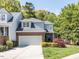 Beautiful two-story townhouse with a two-car garage, brick accents, landscaped yard, and serene surroundings at 3608 Burwell Rollins Cir, Raleigh, NC 27612
