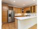 Bright kitchen featuring stainless steel appliances, an island with a white countertop and light wood cabinetry at 3608 Burwell Rollins Cir, Raleigh, NC 27612