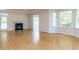 Spacious room with hardwood floors, a fireplace, bay windows offering ample natural light, and white trim at 3608 Burwell Rollins Cir, Raleigh, NC 27612