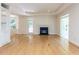 Expansive living room with hardwood floors, a fireplace, built-in shelving, and French doors to an outdoor space at 3608 Burwell Rollins Cir, Raleigh, NC 27612