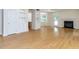 Open-concept living room featuring hardwood floors, built-in shelving, a fireplace, and access to a dining area at 3608 Burwell Rollins Cir, Raleigh, NC 27612