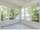 Window-filled sunroom with ceramic tile flooring offering abundant natural light at 3608 Burwell Rollins Cir, Raleigh, NC 27612