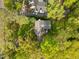 Aerial view of the home showcasing the roof, surrounding trees, long driveway, and lush green lawn at 3612 Darwin Rd, Durham, NC 27707