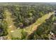 Aerial of a home situated between a golf course and a lush green tree canopy at 3612 Darwin Rd, Durham, NC 27707