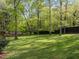 Backyard featuring mature shade trees providing a peaceful setting at 3612 Darwin Rd, Durham, NC 27707