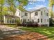 Spacious backyard with deck, mature trees and landscaping surrounding a white two-story home at 3612 Darwin Rd, Durham, NC 27707