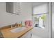 Bright bathroom with a stone countertop, large mirror, and a window providing natural light at 3612 Darwin Rd, Durham, NC 27707