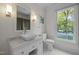 Well-lit bathroom featuring a modern sink, marble countertop, and a window with natural light at 3612 Darwin Rd, Durham, NC 27707