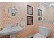 Powder bathroom with patterned wallpaper, pedestal sink, and decorative accents at 3612 Darwin Rd, Durham, NC 27707