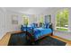 Charming bedroom featuring twin beds with blue accents and plenty of natural light from large windows at 3612 Darwin Rd, Durham, NC 27707