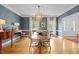 Stylish dining room with blue wallpaper, wood floors, modern lighting, and elegant decor, ideal for hosting dinners at 3612 Darwin Rd, Durham, NC 27707