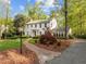 Beautiful two-story home featuring a brick walkway and lush landscaping, creating a welcoming curb appeal at 3612 Darwin Rd, Durham, NC 27707