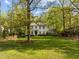 Two-story traditional home surrounded by lush greenery and a well-maintained lawn at 3612 Darwin Rd, Durham, NC 27707
