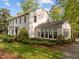 Traditional two-story home featuring a white exterior, well-manicured landscaping, and mature trees at 3612 Darwin Rd, Durham, NC 27707