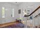 Bright foyer featuring hardwood floors, white trim, and a charming bench, exuding a welcoming ambiance at 3612 Darwin Rd, Durham, NC 27707