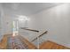 Upstairs hallway featuring hardwood flooring, stairs, and natural light at 3612 Darwin Rd, Durham, NC 27707