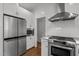 Kitchen with stainless steel appliances, white subway tile backsplash, and hardwood floors at 3612 Darwin Rd, Durham, NC 27707