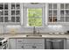 Bright kitchen features shaker cabinets, stainless steel appliances, and window view to the outdoors at 3612 Darwin Rd, Durham, NC 27707