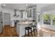 Bright kitchen with stainless appliances, counter seating, and view to outdoor deck at 3612 Darwin Rd, Durham, NC 27707