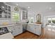 Spacious white kitchen with stainless appliances, center island, and view to living room at 3612 Darwin Rd, Durham, NC 27707