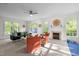 Spacious living room with ample seating, a fireplace, a ceiling fan, and large windows providing natural light at 3612 Darwin Rd, Durham, NC 27707