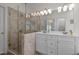 The main bathroom features a glass-enclosed shower, dual sinks, modern lighting, and tiled walls at 3612 Darwin Rd, Durham, NC 27707