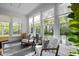 Sun-drenched sitting room with comfortable seating, neutral colors, and views to the outdoors at 3612 Darwin Rd, Durham, NC 27707