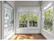 Sunroom with bright windows and neutral decor offers a relaxing indoor/outdoor living space at 3612 Darwin Rd, Durham, NC 27707