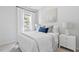Cozy bedroom featuring a window and comfortable queen bed with decorative pillows at 3667 Durwood Ln, Raleigh, NC 27604