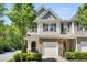 Inviting two-story townhouse with stone accents, attached garage, tidy landscaping, and charming curb appeal at 3667 Durwood Ln, Raleigh, NC 27604