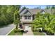 Two-story townhouse featuring stone veneer, attached garage, landscaped yard, and inviting curb appeal at 3667 Durwood Ln, Raleigh, NC 27604