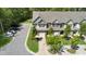 Well-maintained two-story townhomes with attached garages, mature trees, and a green, landscaped lawn at 3667 Durwood Ln, Raleigh, NC 27604