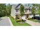 Attractive townhome showcasing manicured lawn, attached garage, and a well-maintained exterior on a sunny day at 3667 Durwood Ln, Raleigh, NC 27604