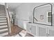 Bright foyer with hardwood floors, staircase, decorative table, stylish mirror, and elegant decor at 3667 Durwood Ln, Raleigh, NC 27604