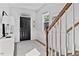 Inviting foyer with staircase, natural light, console table, black front door, and neutral decor at 3667 Durwood Ln, Raleigh, NC 27604